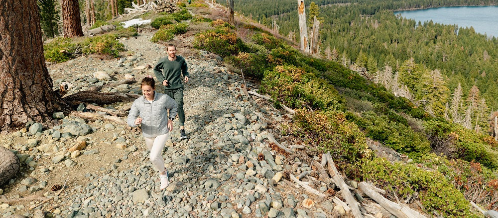 Man and woman trail running
