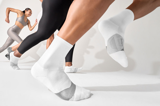 Women running in pairs of Feetures crew socks