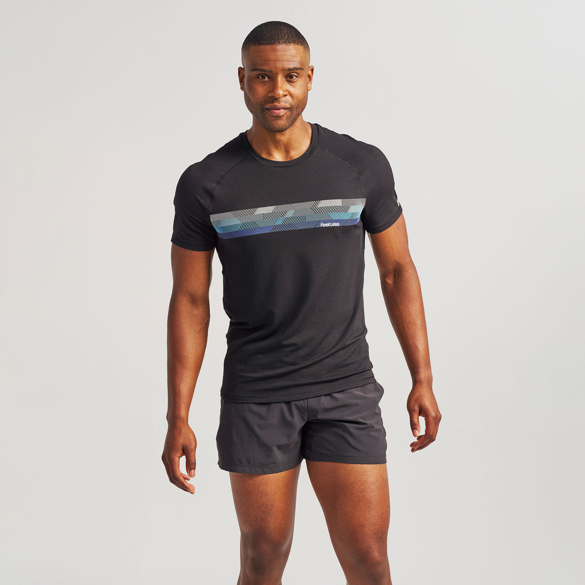 Men’s Stride Flex Performance Tee - Black Feetures Graphic | model: Jalen - Wearing Size Medium - Waist 32 Inseam 33 Chest 40